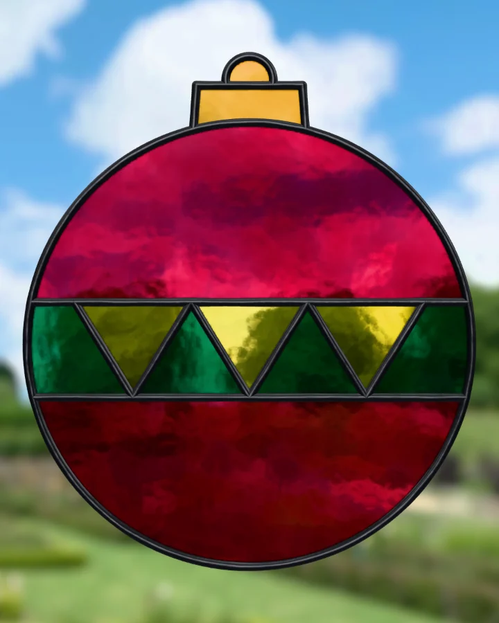 Christmas bauble suncatcher glazed, lit from behind.